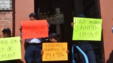 Police officers symbolically close Chapala City Hall to stress demands