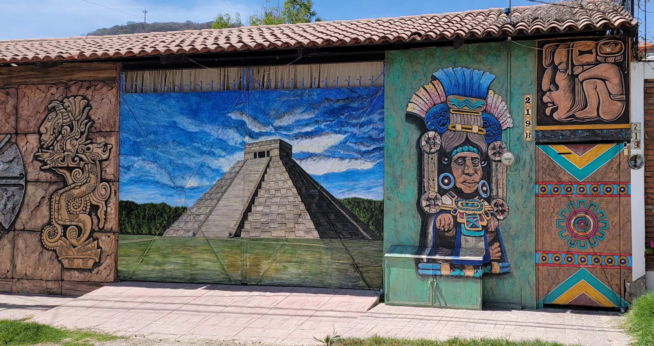 Panorama of a pyramid and Aztec symbology and gods.